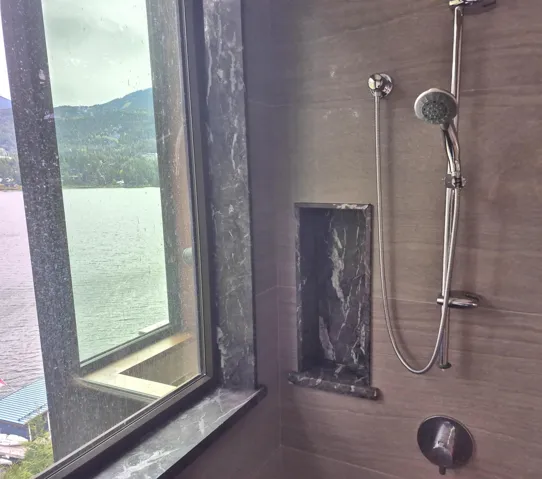 Full bathroom featuring plenty of natural light and tiled shower