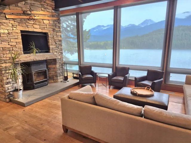 Living room with hardwood / wood-style floors and a stone fireplace