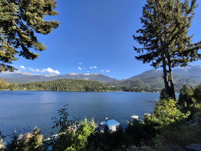 Water view with a mountainous background and a heavily wooded area
