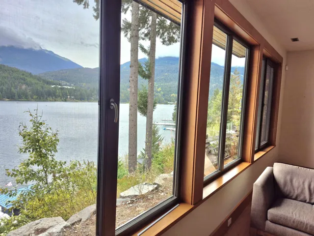 Doorway to outside featuring a water and mountain view and a view of trees