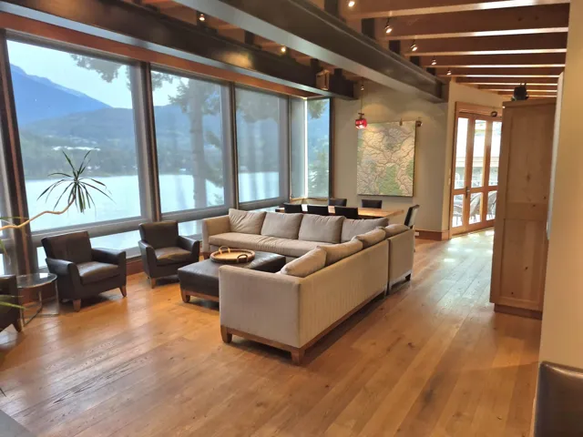 Living area with light wood-type flooring, beam ceiling, and a mountain view