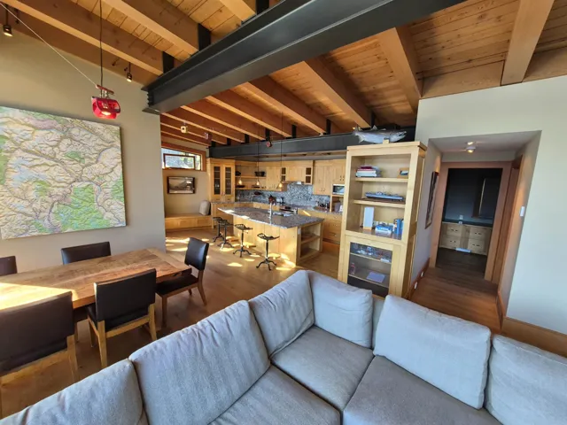 Living area with wood finished floors and a wood ceiling with exposed beams