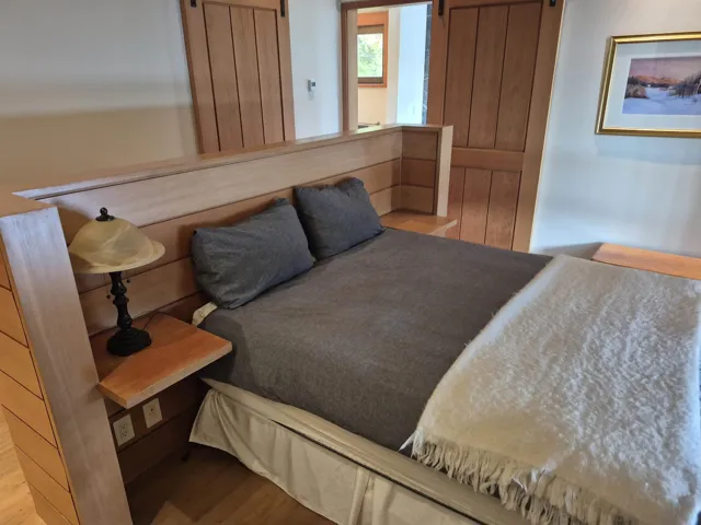 Bedroom featuring a barn door and wood finished floors