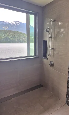 Bathroom featuring tiled shower and a mountain view
