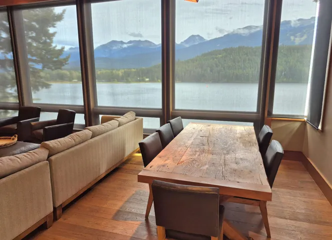 Dining room featuring a water view, light wood-type flooring, and plenty of natural light