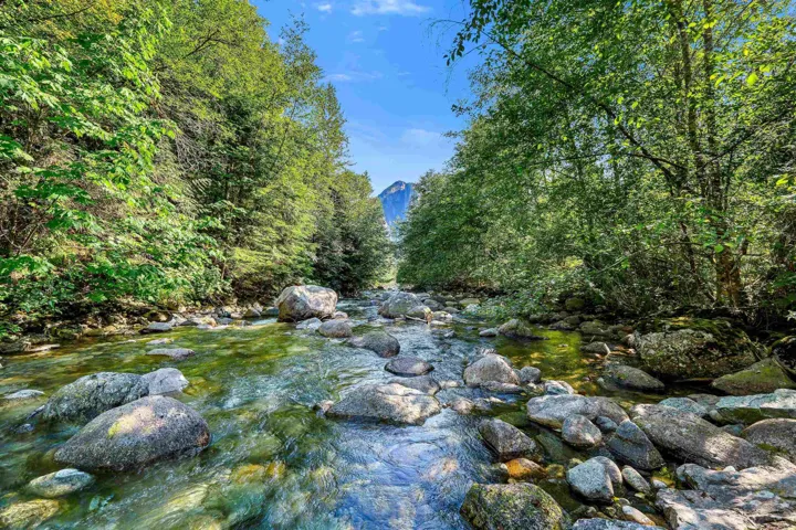 Natural creek featuring clear water and numerous large stones