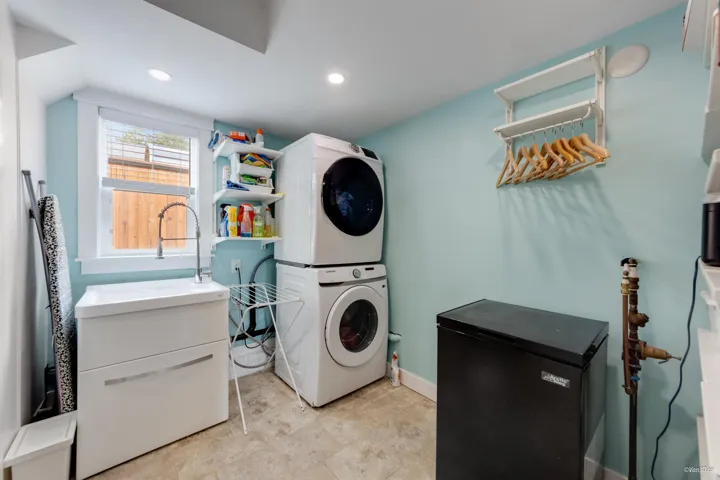 Washroom featuring estacked washer and dryer, recessed lighting, and baseboards