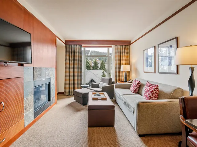 Living room with a tile fireplace and carpet floors