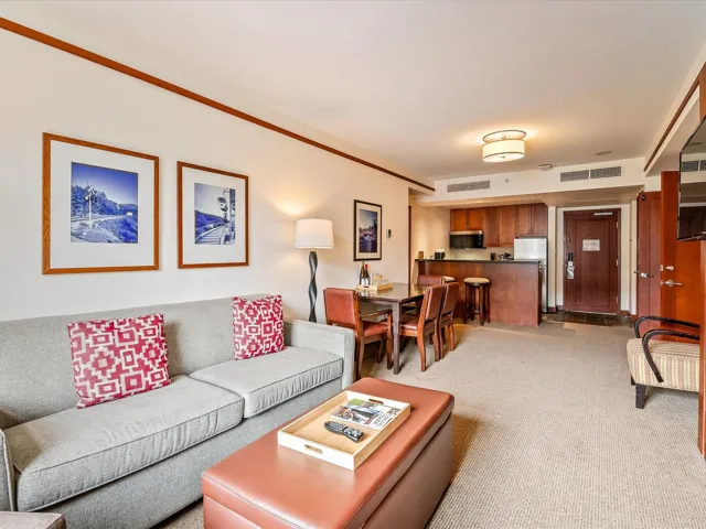 Living area with light carpet and visible vents