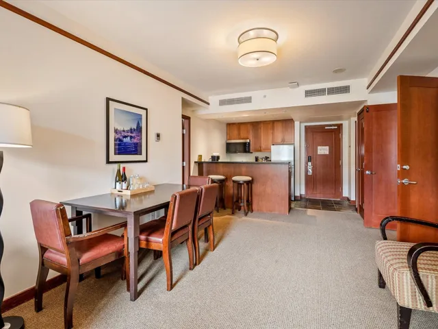 Dining area with light colored carpet, baseboards, and visible vents