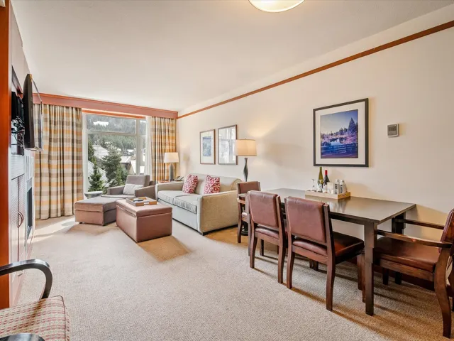 Carpeted living room featuring ornamental molding