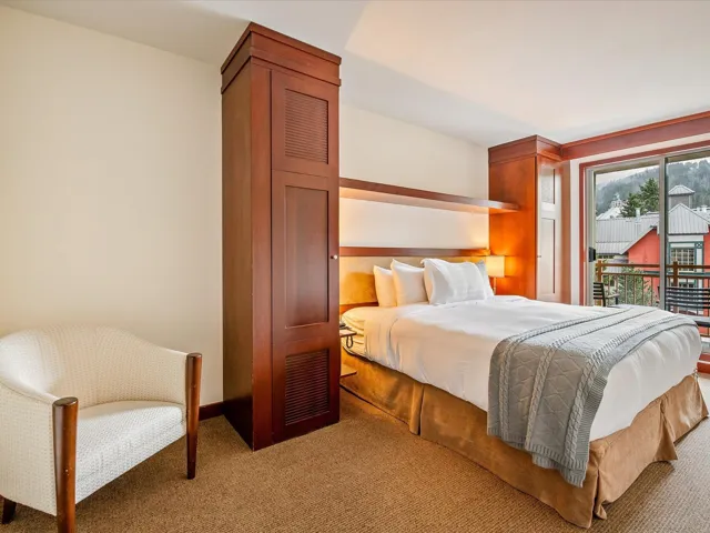 Bedroom featuring access to exterior, light colored carpet, and baseboards