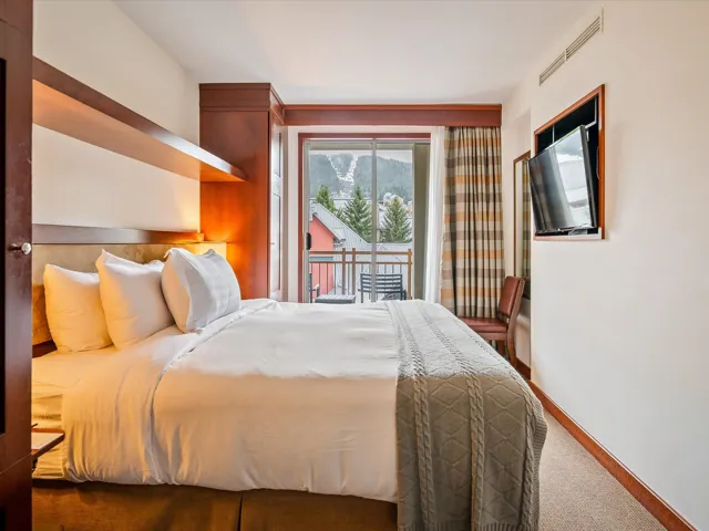Carpeted bedroom featuring visible vents, access to exterior, and baseboards