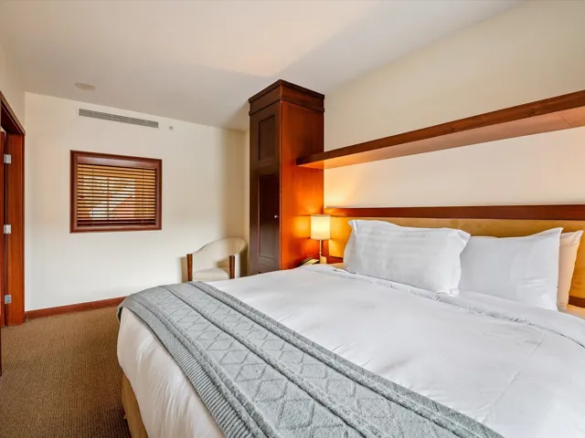 Carpeted bedroom featuring visible vents and baseboards