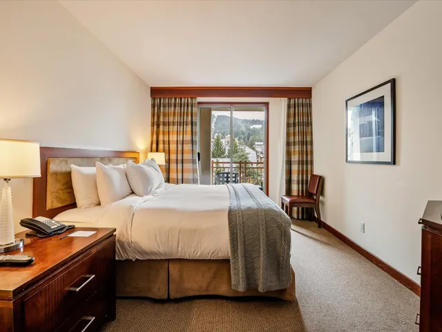 Carpeted bedroom featuring access to outside and baseboards
