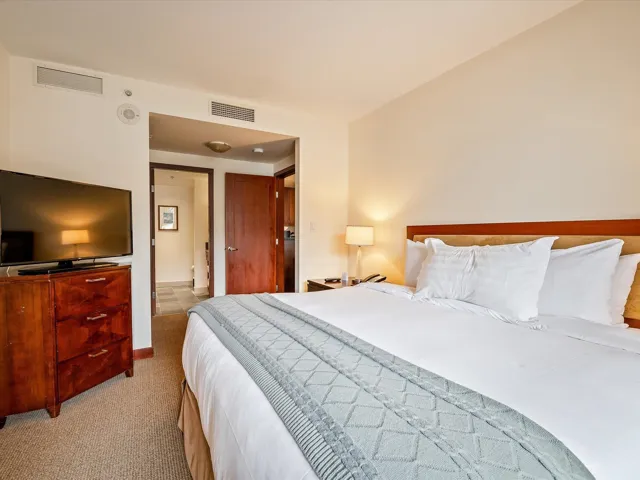 Bedroom featuring light carpet and visible vents