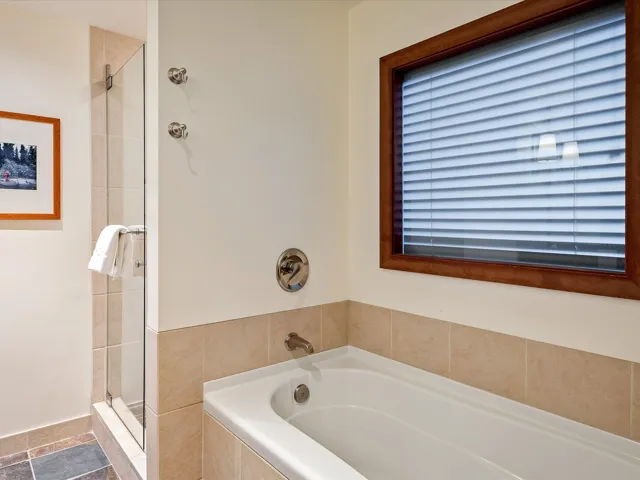 Full bathroom with a stall shower and a garden tub