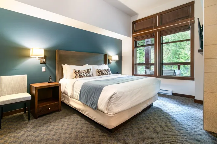 Carpeted bedroom featuring a baseboard radiator