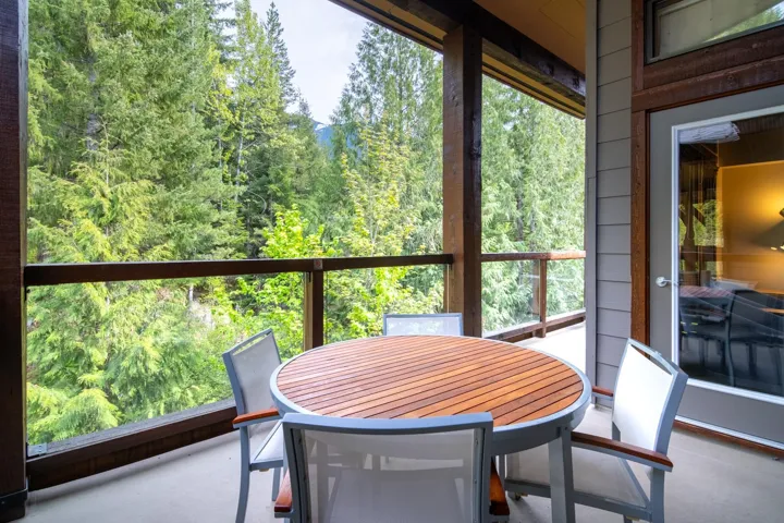 Sunroom / solarium with a forest view