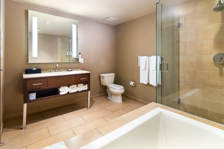 Full bathroom with a shower stall, toilet, tile patterned flooring, baseboards, and vanity
