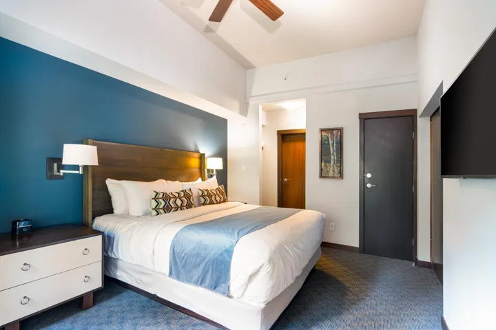 Carpeted bedroom featuring a ceiling fan