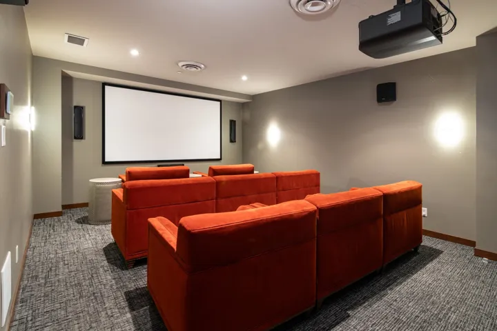 Home theater featuring dark carpet, baseboards, and recessed lighting