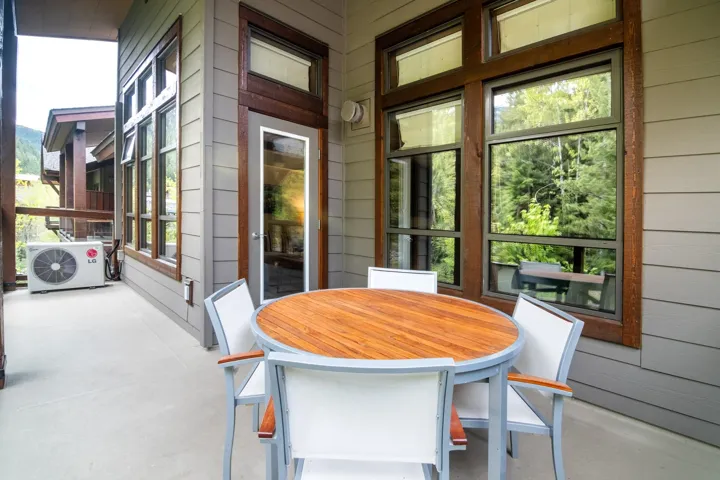 Sunroom featuring ac unit, wooden walls, and finished concrete flooring