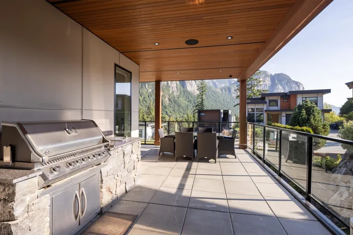Patio / terrace featuring exterior kitchen, a mountain view, and outdoor dining space