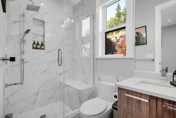 Full bathroom with vanity and a marble finish shower