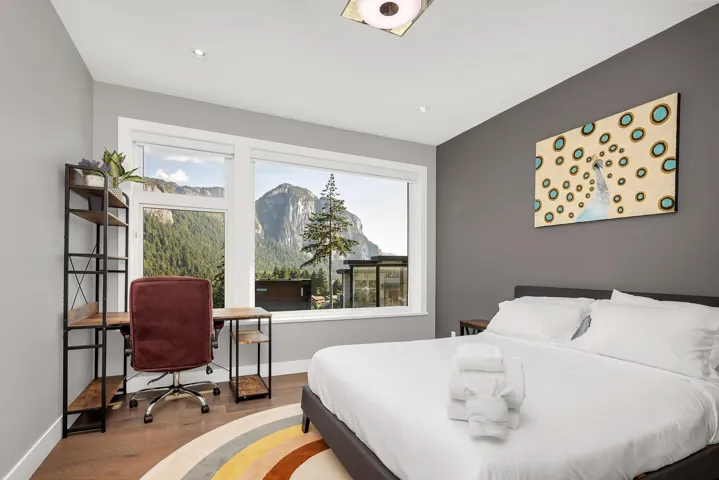 Bedroom with wood finished floors, recessed lighting, a desk, and a mountain view