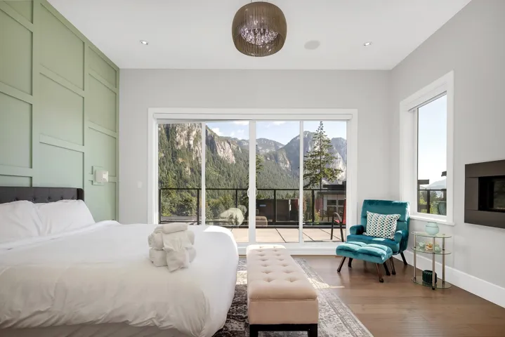 Bedroom featuring access to exterior, wood finished floors, a mountain view, and recessed lighting
