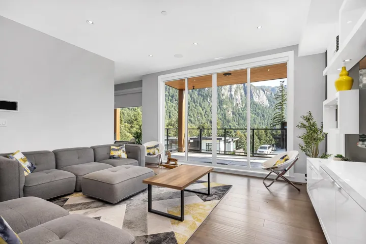 Living area featuring healthy amount of natural light, light wood-style flooring, and recessed lighting