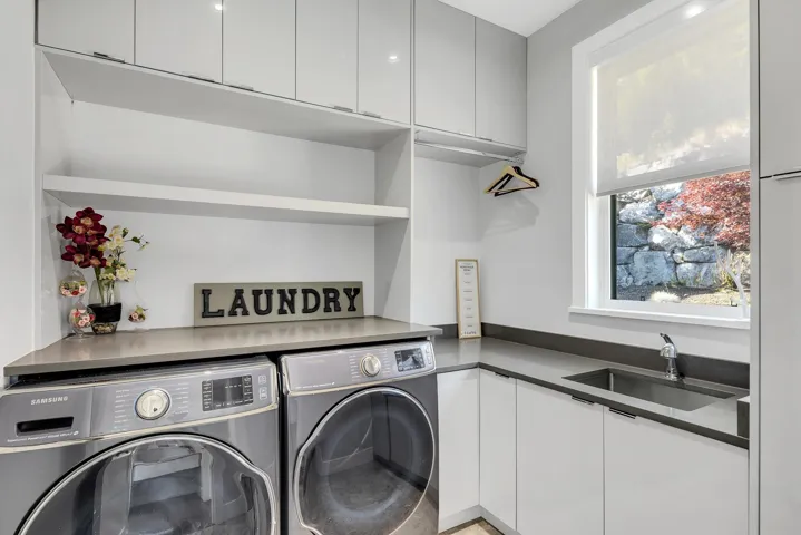 Washroom with separate washer and dryer and cabinet space