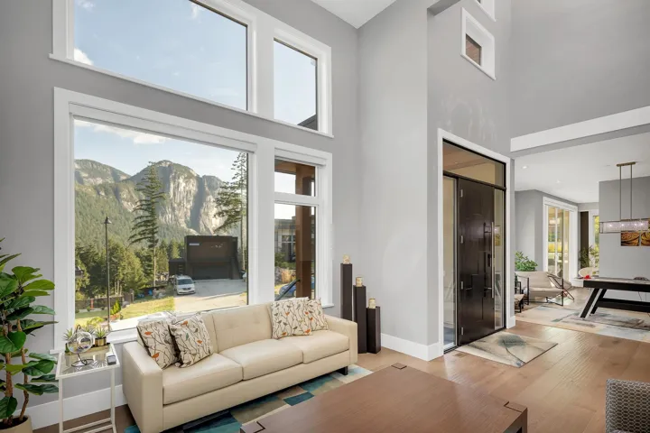 Living area featuring wood finished floors, a towering ceiling, and a mountain view