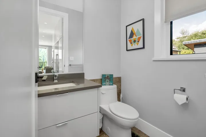 Half bathroom with toilet and vanity