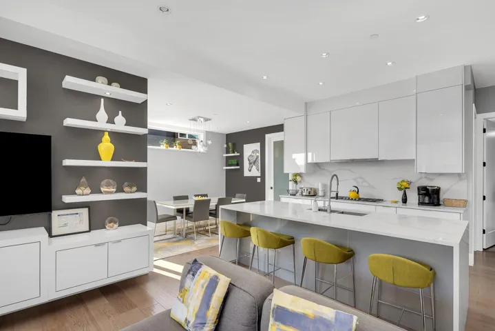Kitchen with wood finished floors, modern cabinets, tasteful backsplash, white cabinets, and recessed lighting