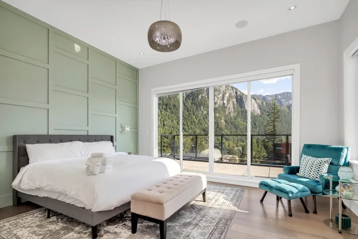 Bedroom with light wood-style flooring, a mountain view, access to exterior, recessed lighting, and a forest view