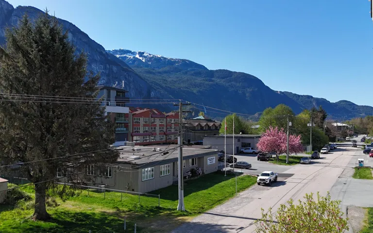 Mountainous backdrop featuring snow-capped peaks and verdant lower slopes