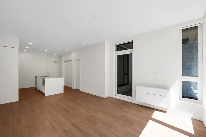 Open concept living space featuring wood-finish flooring and recessed lighting