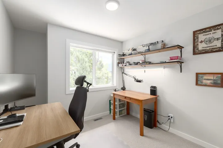 Office space featuring light carpet and baseboards