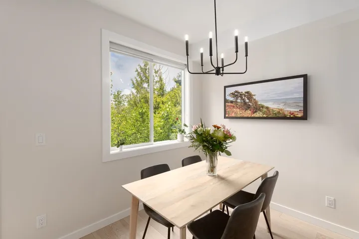 Dining room featuring baseboards, a chandelier, and light wood-type flooring