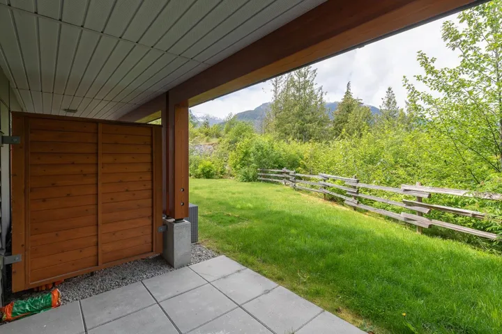 View of yard featuring a mountain view, a wooded view, and a patio