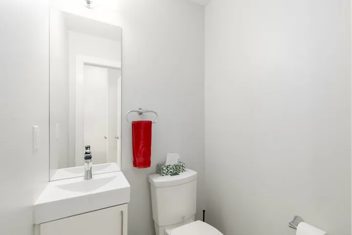 Half bathroom with toilet and vanity
