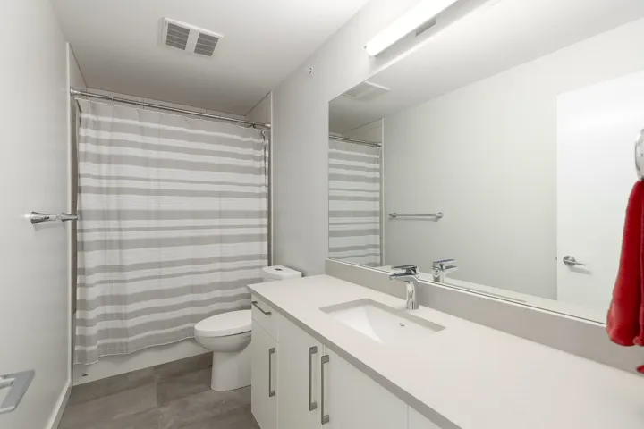 Bathroom with toilet, vanity, and tile patterned flooring