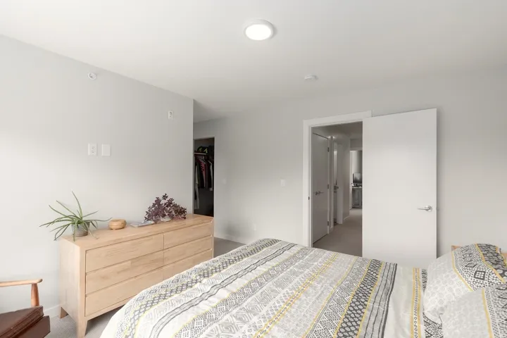 Bedroom featuring light colored carpet and baseboards