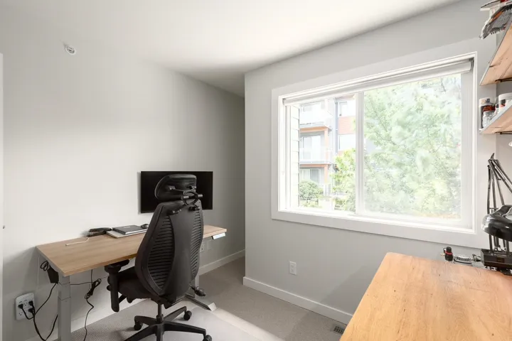 Carpeted office space with healthy amount of natural light and baseboards