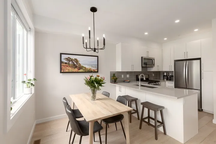 Dining space with plenty of natural light, baseboards, light wood-type flooring, a chandelier, and recessed lighting