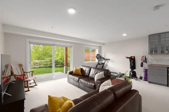 Carpeted living room with recessed lighting