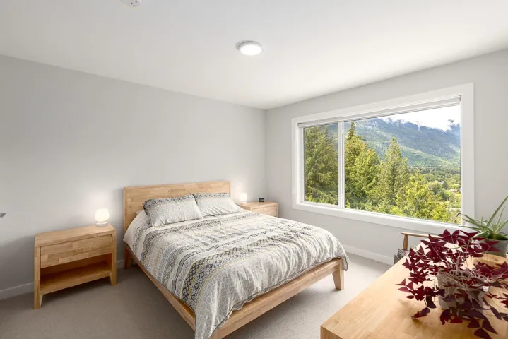 Bedroom with light carpet and baseboards