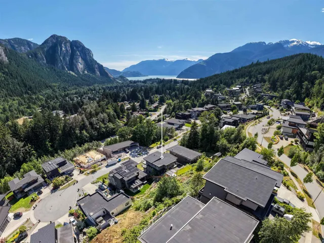 Aerial perspective showcasing a residential community nestled within a mountainous landscape